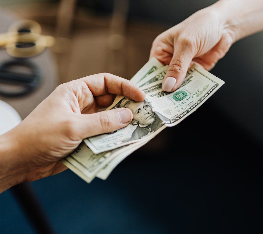 Hands Holding Us Dollar Bills